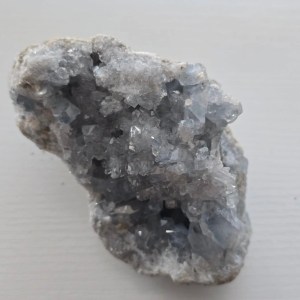 Close-up of a Celestite Crystal Geode showcasing soft sky-blue hues and natural textures