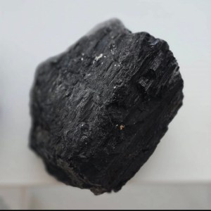 Close-up of a Raw Black Tourmaline showcasing its deep, natural black texture and rugged form