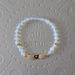 Opalite bracelet with gold embellishments, heart charm, and angel wings charm