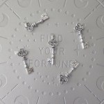 A key-shaped pendant with detailed patterns on the handle.