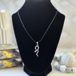 A serpent-shaped pendant hanging from a 22" inch korean wax black cord, displayed against a mystical background.