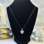 A heart-shaped pendant necklace called Oneness Heart Necklace, showcasing a delicate and elegant design that symbolizes unity and harmony.