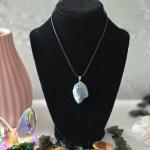 A rough blue apatite pendant hanging from a sturdy Korean wax black cord