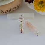 Five stunning rose quartz chakra pendant displayed on a piece of natural selenite stick.