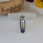 A stunning sodalite chakra pendant displayed on a piece of natural selenite stick.