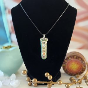 A stunning aventurine chakra necklace displayed on a black velvet display, featuring a 22-inch Korean Wax Black cord.