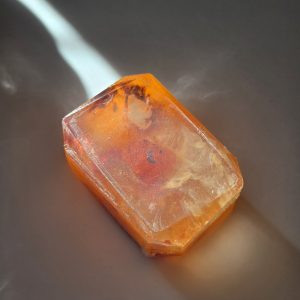 A luxurious crystal bar soap with a carnelian stone, offering warmth and creativity-boosting properties.