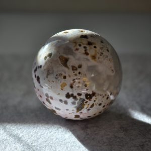 A beautifully carved Ocean Jasper sphere with druzy, perfect for expressing mystical love and tranquility on Valentine's Day.
