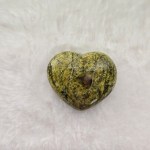 Ethically sourced serpentine heart-shaped stone with smooth, natural curves on a clean background