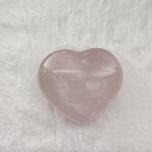 Ethically sourced rose quartz heart-shaped stone with soft pink hues and smooth carved contours