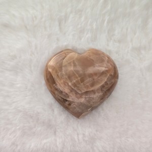 Ethically sourced Honey Calcite heart-shaped stone with warm hues and smooth carved contours