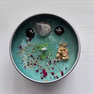 Rebirth Crystal Candle - Top view showcasing Clear Quartz and Garnet crystals with botanical elements