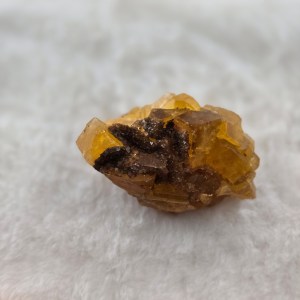 Close-up of a honey golden calcite stone with warm, translucent hues and layered formations