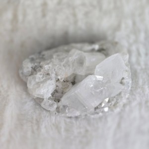 Image: A stunning Clear Quartz Cluster with naturally formed crystal points, radiating clarity and high vibrational energy.