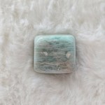 Close-up of a single Amazonite tumbled stone, highlighting its smooth surface and soothing colors.