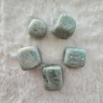 A collection of polished Amazonite tumbled stones, showcasing their calming blue-green hues with natural patterns.