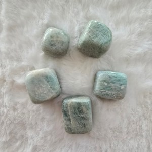 A collection of polished Amazonite tumbled stones, showcasing their calming blue-green hues with natural patterns.