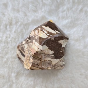 Ethically sourced Zebra Jasper point showcasing distinctive white stripes on a rich brown background and smooth natural contours