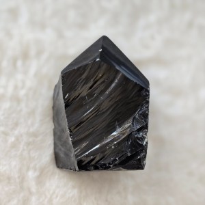 Ethically sourced Black Obsidian Point with sleek reflective surfaces and sharp, defined edges