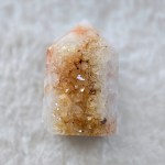 Ethically sourced citrine cluster point with a refined cut base, showcasing vibrant yellow hues and sparkling facets